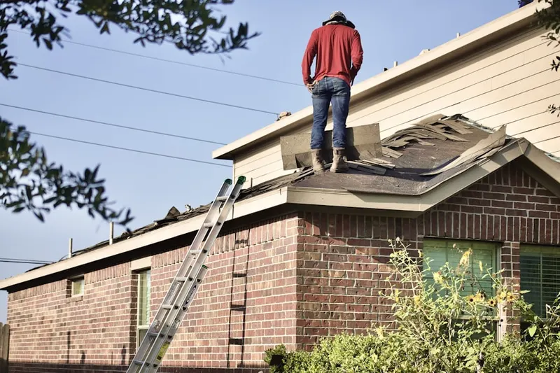 Professional roofer working on a residential roof in Verona Station